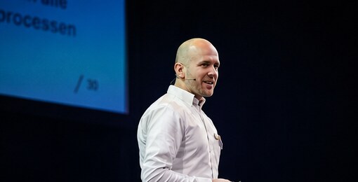 Carlo speaking on stage.